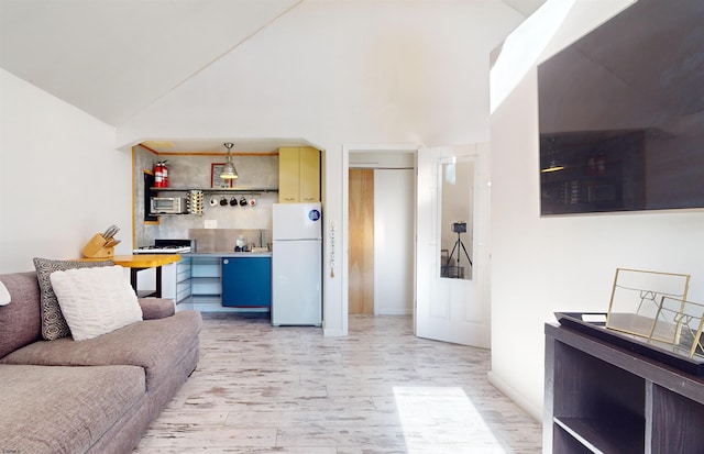 living room featuring light wood-type flooring and vaulted ceiling