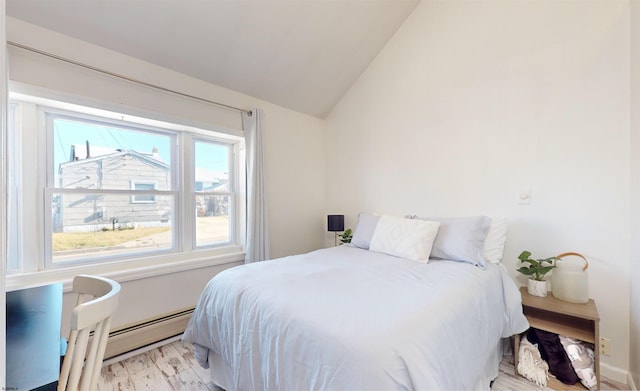 bedroom with light hardwood / wood-style floors and lofted ceiling