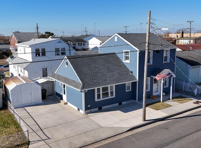 view of front facade with a storage shed