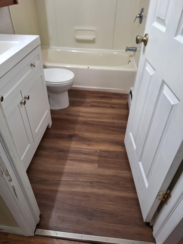 full bathroom featuring bathtub / shower combination, wood-type flooring, toilet, and vanity