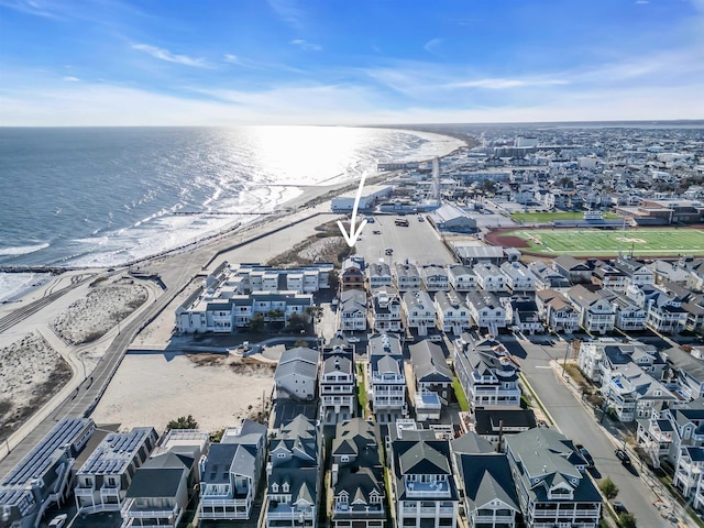 bird's eye view featuring a water view and a beach view