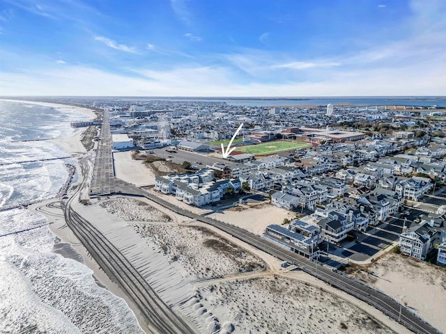 aerial view with a water view and a beach view