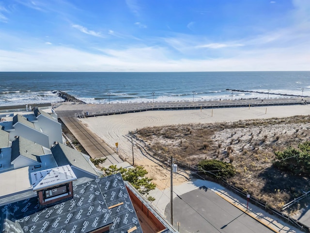 birds eye view of property featuring a beach view and a water view