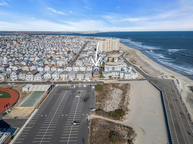 drone / aerial view with a beach view and a water view