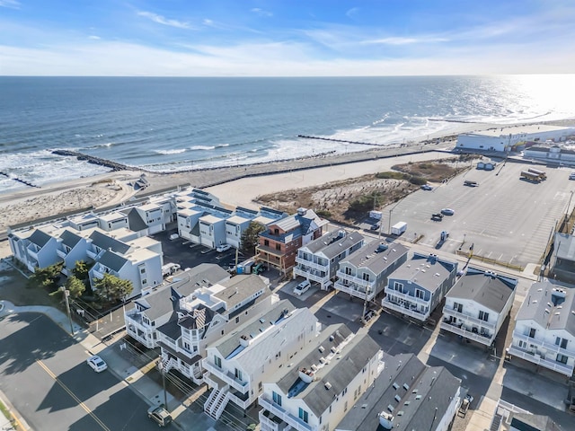 birds eye view of property featuring a beach view and a water view