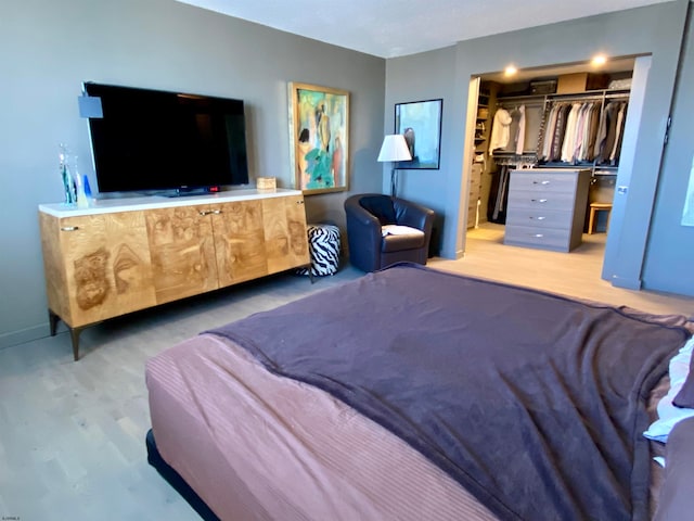 bedroom with a closet and hardwood / wood-style floors