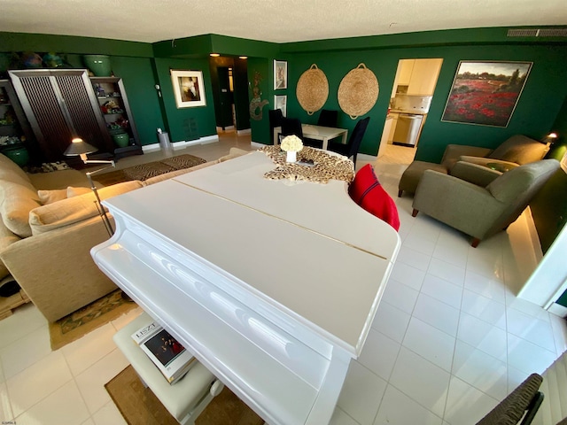 interior space featuring tile patterned flooring and a textured ceiling