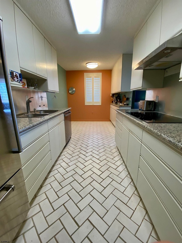 kitchen with white cabinets, appliances with stainless steel finishes, and sink