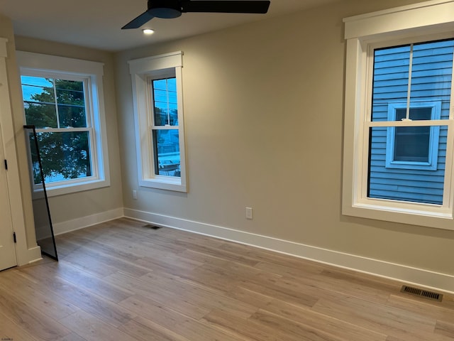 spare room featuring light hardwood / wood-style flooring and ceiling fan