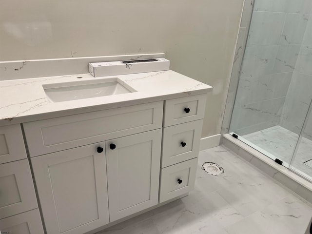 bathroom with vanity and a shower with door