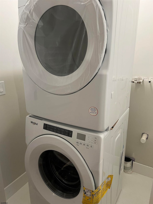 laundry room with stacked washer / drying machine