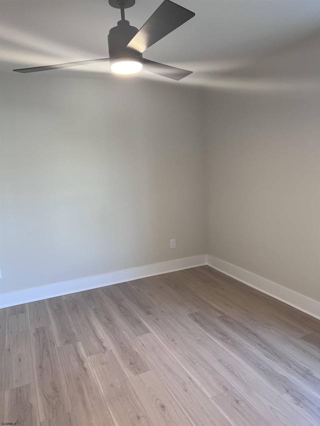 spare room featuring light hardwood / wood-style flooring and ceiling fan