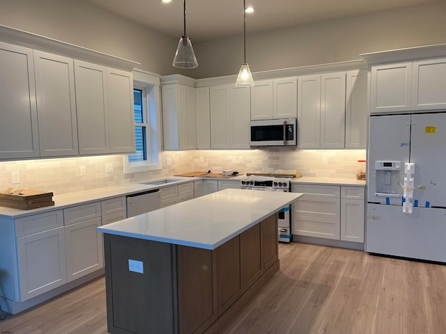 kitchen featuring a kitchen island, white cabinetry, appliances with stainless steel finishes, and light hardwood / wood-style floors