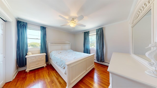 bedroom with multiple windows, ceiling fan, ornamental molding, and hardwood / wood-style flooring