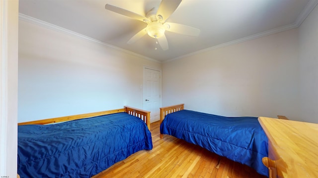 bedroom with ceiling fan, light hardwood / wood-style flooring, and ornamental molding