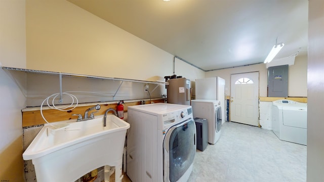 clothes washing area with independent washer and dryer, sink, electric panel, and water heater