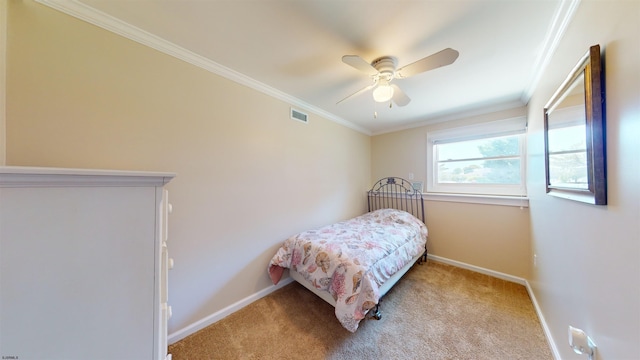 carpeted bedroom with ceiling fan and crown molding