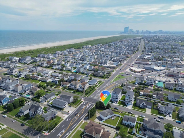 bird's eye view with a water view and a beach view