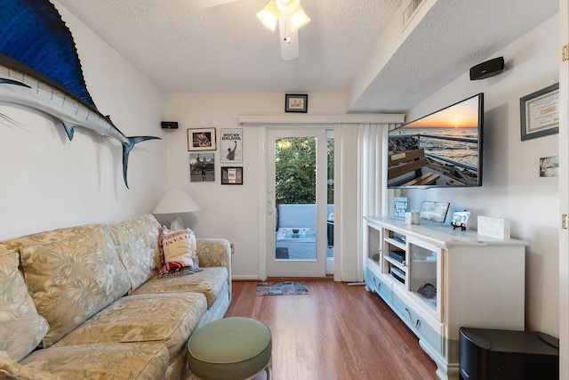 living room with hardwood / wood-style floors and a textured ceiling