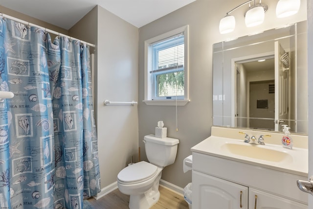 bathroom featuring vanity, toilet, wood-type flooring, and walk in shower