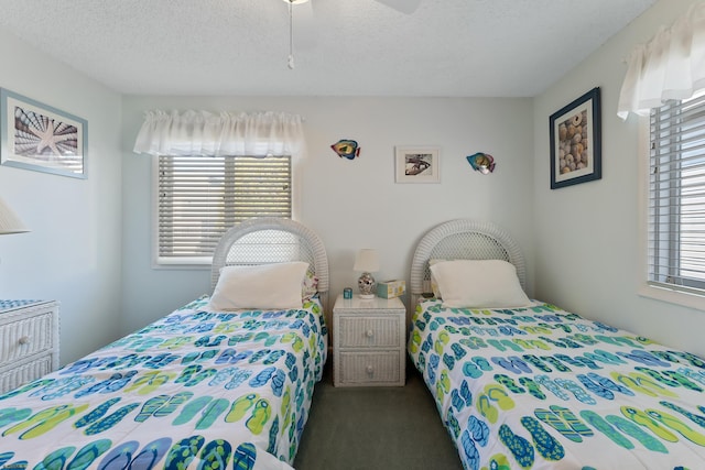 bedroom with carpet, a textured ceiling, and ceiling fan