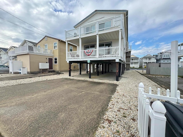 raised beach house with a carport and a balcony