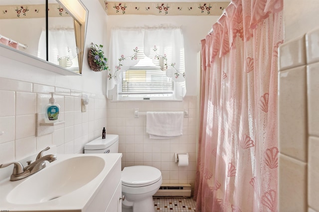 bathroom featuring vanity, a baseboard heating unit, tile walls, and toilet