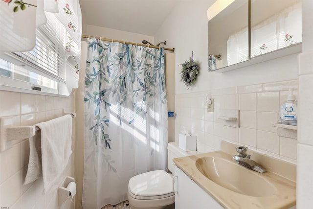 bathroom featuring walk in shower, tile walls, vanity, and toilet