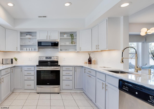 kitchen with white cabinetry, sink, light tile patterned floors, and stainless steel appliances