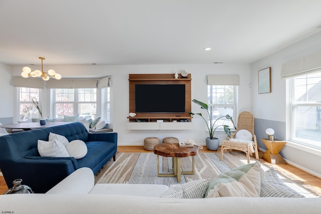 living room featuring a notable chandelier and light hardwood / wood-style flooring