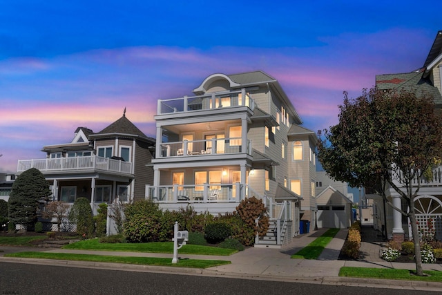 view of front of property featuring a balcony and a garage