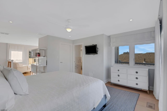 bedroom with ceiling fan and light wood-type flooring