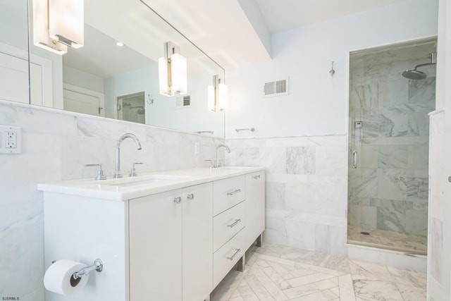 bathroom with an enclosed shower, vanity, and tile walls