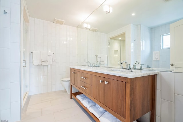 bathroom featuring walk in shower, tile patterned flooring, toilet, vanity, and tile walls