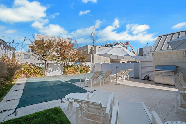 view of swimming pool featuring a patio area and a grill