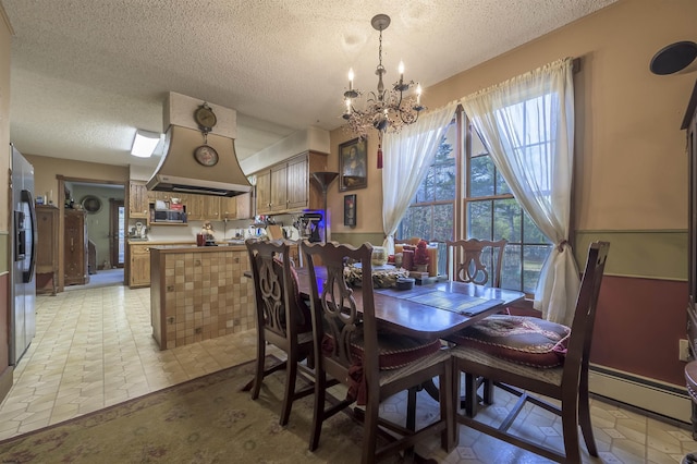 dining space featuring a chandelier and a textured ceiling