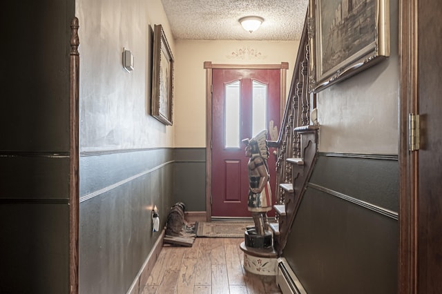 entryway featuring a textured ceiling and light wood-type flooring