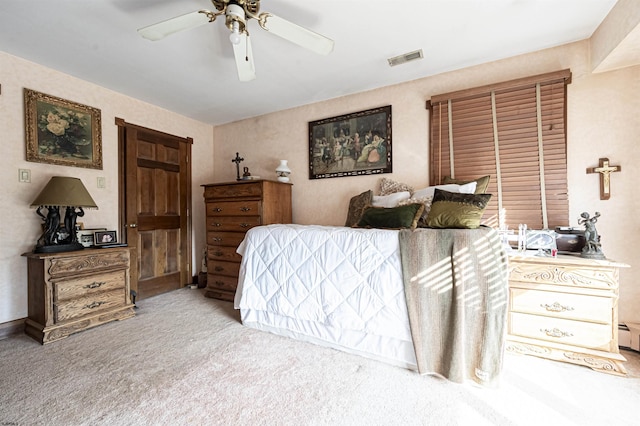 bedroom featuring light carpet, baseboard heating, and ceiling fan