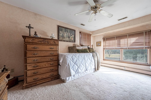 carpeted bedroom with ceiling fan and a baseboard radiator