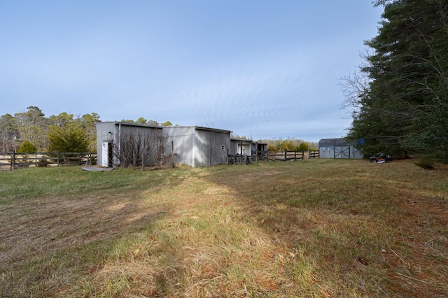 view of yard with an outbuilding and a rural view