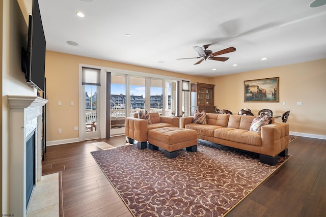 living room with ceiling fan and hardwood / wood-style flooring