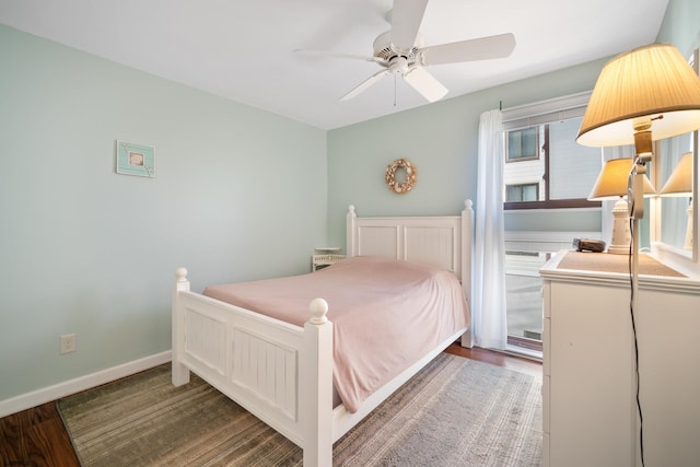 bedroom with dark hardwood / wood-style flooring and ceiling fan