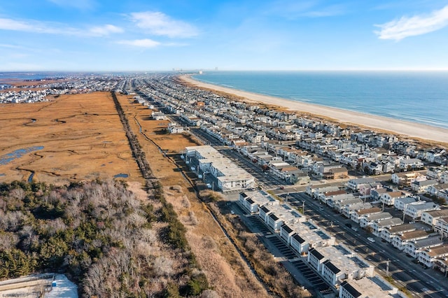 drone / aerial view featuring a water view and a view of the beach