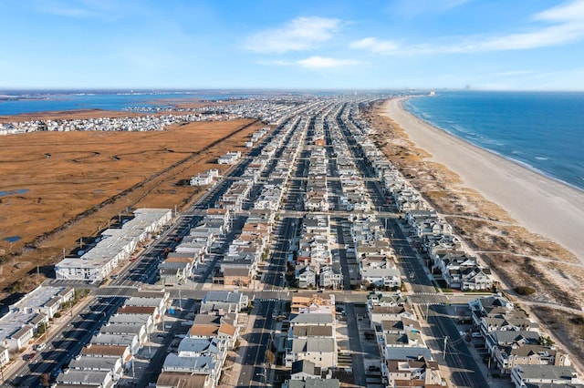 drone / aerial view featuring a water view and a view of the beach