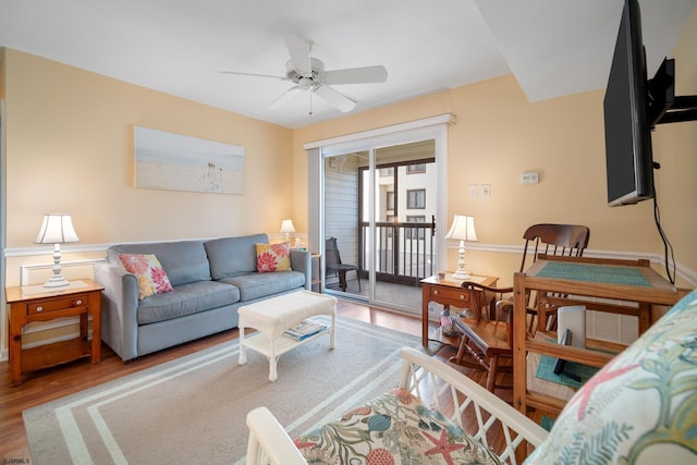 living room featuring ceiling fan and hardwood / wood-style floors