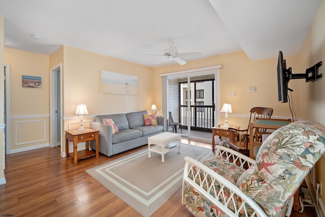 living room with hardwood / wood-style flooring and ceiling fan