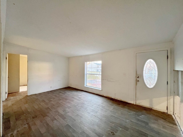 entrance foyer featuring dark hardwood / wood-style floors and lofted ceiling