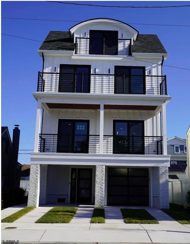 view of front of home featuring a garage and a balcony