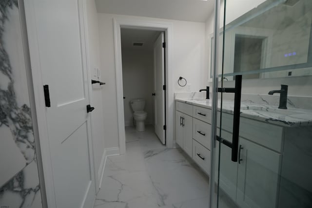 bathroom featuring toilet and vanity