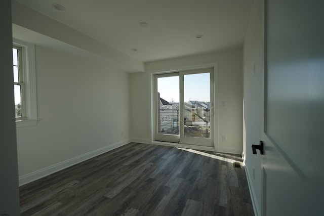 spare room featuring dark wood-type flooring